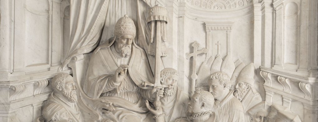 Marble relief with historical figures and religious symbols.