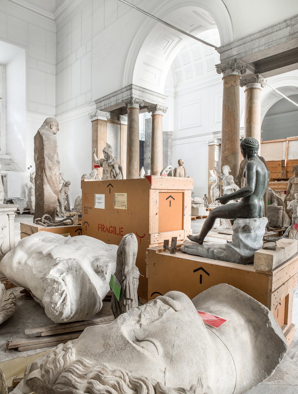 Some of the sculptures are stored in transport crates in a room.