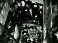 Große Menschenmenge bewegt sich auf einer Treppe innerhalb eines Gebäudes. Die Aufnahme zeigt viele Personen aus der Vogelperspektive.