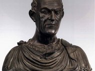 Bronze bust with Roman-style drapery and engraved text.