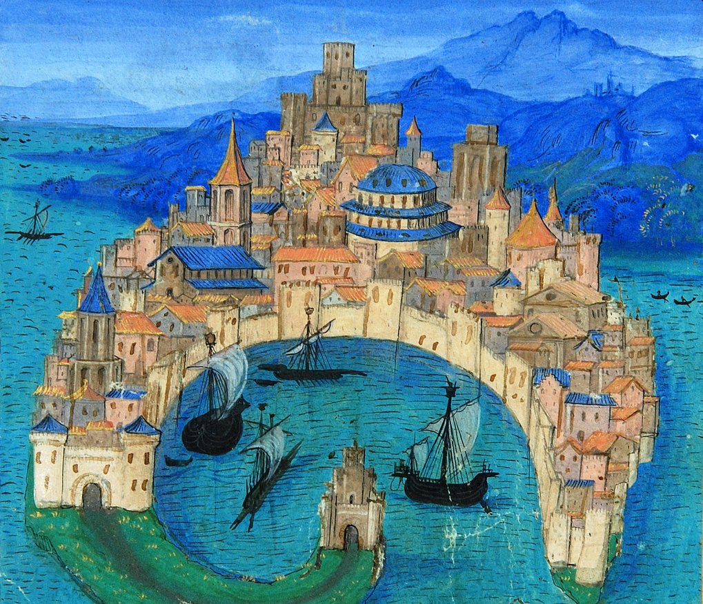 Circular medieval city with fortified walls, surrounded by blue sea. Three ships are anchored in the harbor.