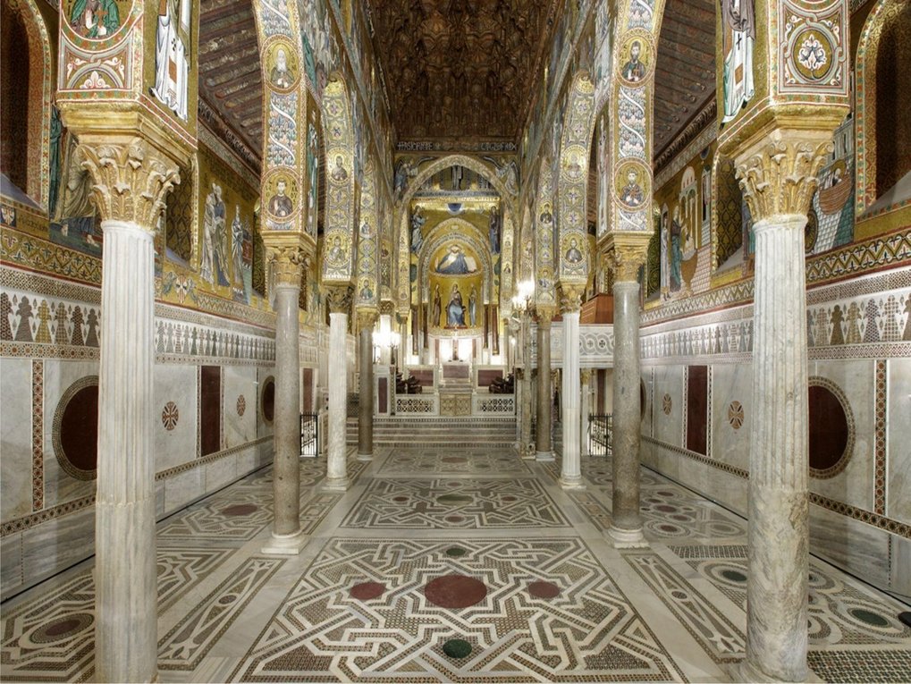 Interior featuring mosaic-adorned columns, detailed frescoes, and a geometric patterned floor leading to an altar.